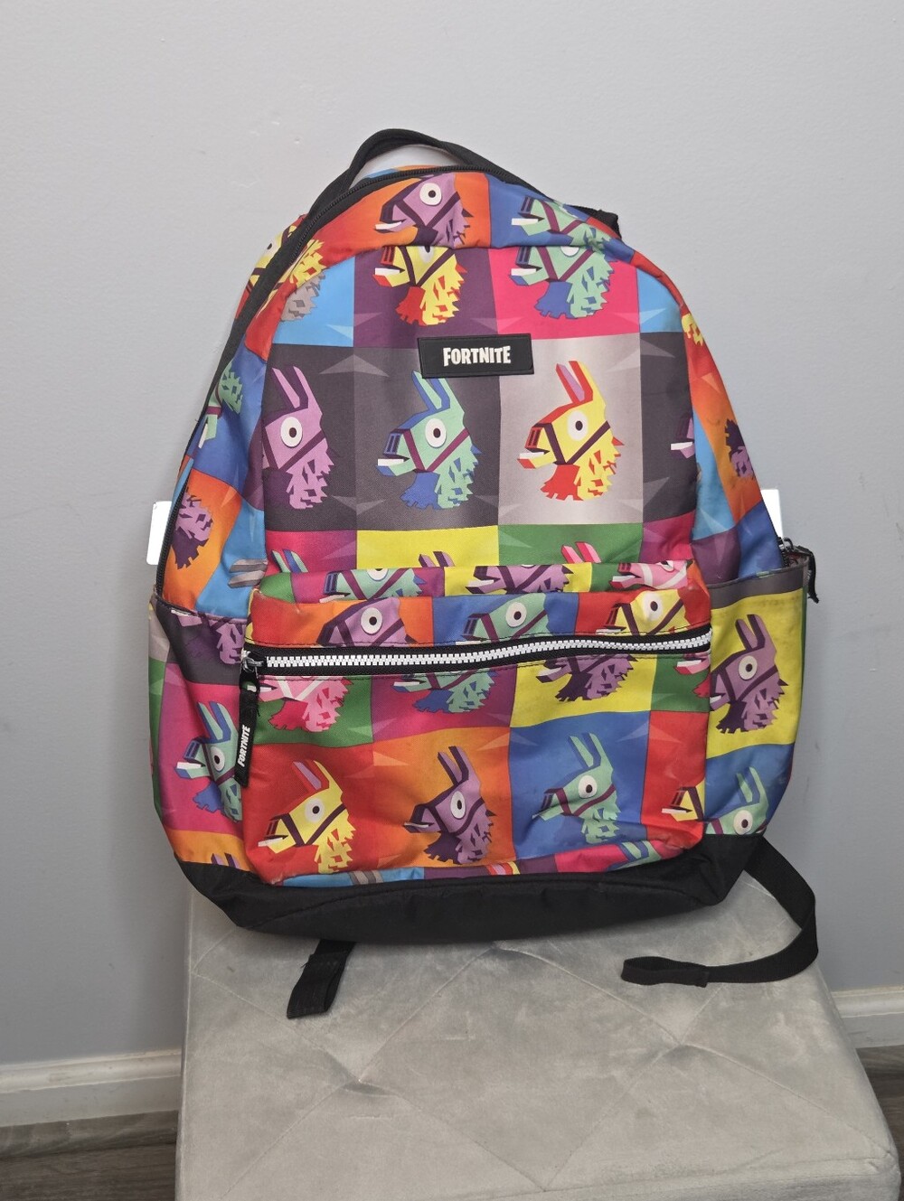 Fortnite Unisex Backpack Features a Vibrant, Multi-colored Llama Pattern.